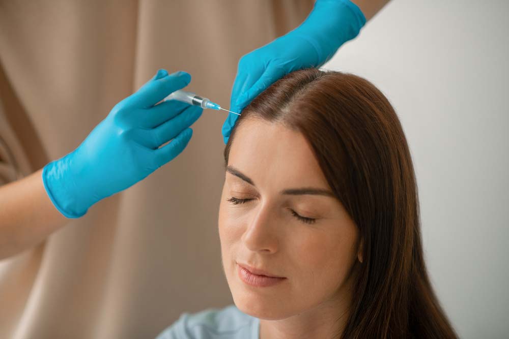 woman receiving hair restoration treatment